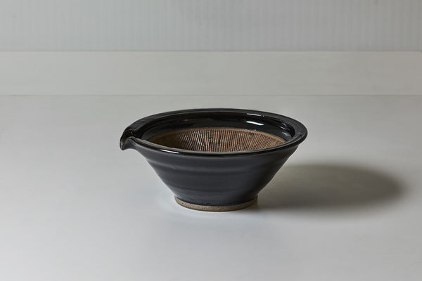 ツヤのある黒飴釉と素朴な土とのコントラストが美しい。